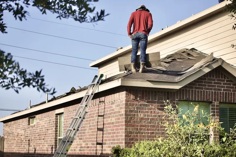 Professional roofer working on a residential roof in Stephenson
